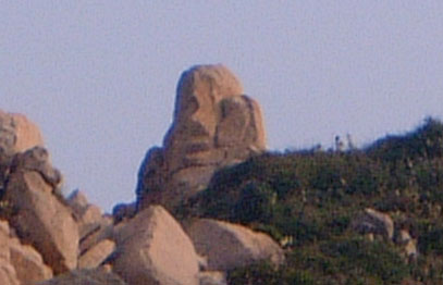 Monkey-looking rock on top of hill