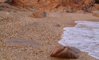 Waves washing up onto beach of pebbles