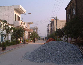 A view of a street with houses under construction