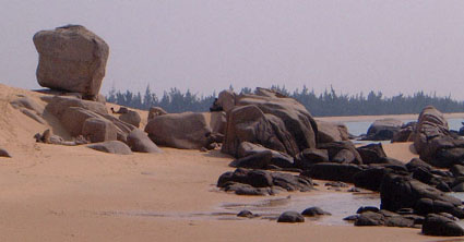 A rock resembles the head of a woman looking out to sea