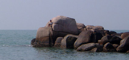 Boy fishing off a rock