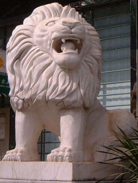 Western-influenced stone lions in Haikou (female) - diagonal view