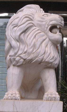 Western-influenced stone lion in Haikou (female) - frontal view