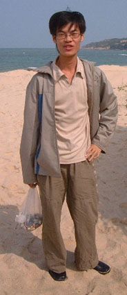 A young Hainanese fellow with a plastic bag full of pebbles